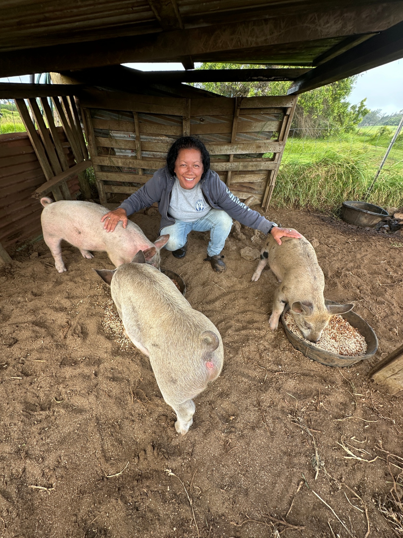 Charisse Ala with her pigs at Kahuaola Farms
